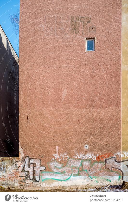 Rötliche Brandmauer, einsames Fenster, Graffiti und geometrische Formen Wand rot allein rötlich vertikal Berlin Mietshaus einzig Ausblick wohnen