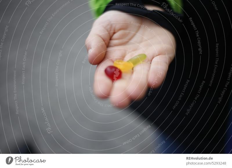 Süßigkeiten in der Hand Bonbon niedlich Gummibärchen Ernährung ungesund lecker mehrfarbig Kindheit Kinderhand