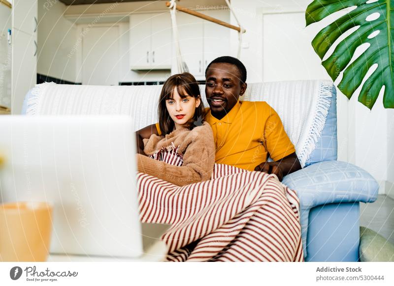Ehepaar benutzt Laptop im Wohnzimmer zu Hause Paar benutzend Sofa Partnerschaft Browsen Zusammensein Zeit verbringen vielfältig online heimwärts