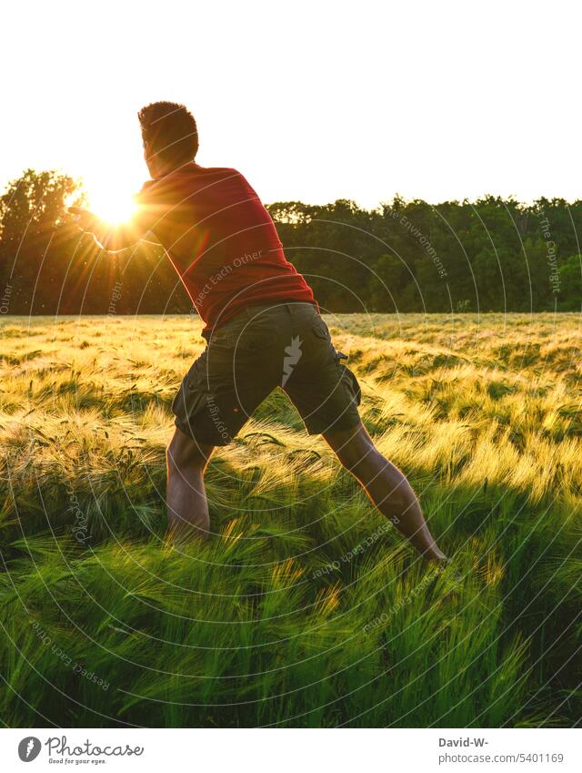 Die Sonne einfangen Sonnenlicht Feld Mann magisch Sonnenuntergang fliegen Natur Licht Umwelt