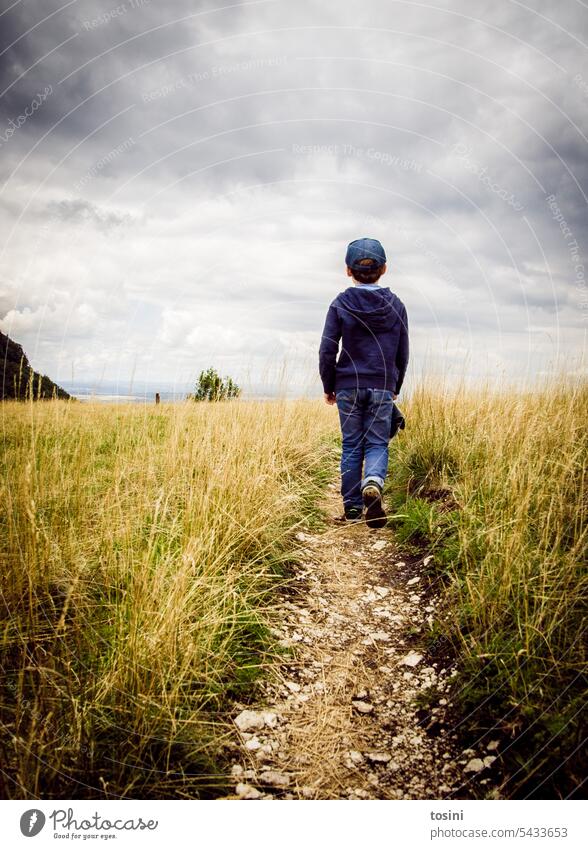 Kind läuft auf einem engen Pfad in Richtung des Horizonts Pfad folgen Wanderung Himmel wandern Wege & Pfade Spaziergang Einsamkeit ruhig Fußweg Landschaft Natur