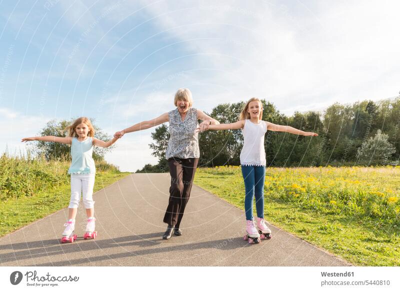 Großmutter und Enkelinnen beim Rollschuhlaufen Enkeltochter Enkeltöchter Rollschuhlaufend Rollschuh laufen Rollschuh laufend Grossmutter Oma Grossmama