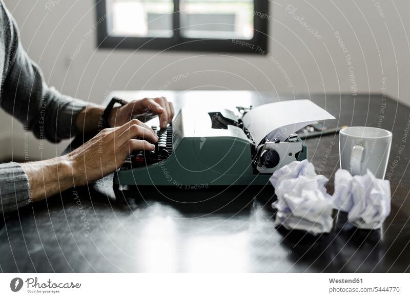 Nahaufnahme eines Schreibmaschinenbenutzers mit zerknittertem Papier auf dem Schreibtisch tippen Mann Männer männlich Arbeitstisch Schreibtische Erwachsener