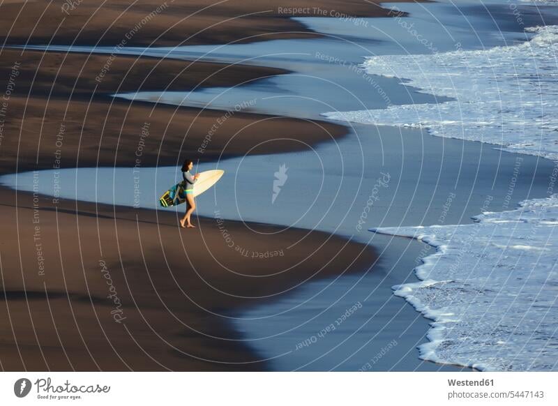 Indonesien, Bali, junge Frau mit Surfbrett Surferin Wellenreiterinnen Surferinnen gehen gehend geht Freizeit Muße Surfbretter surfboard surfboards weiblich