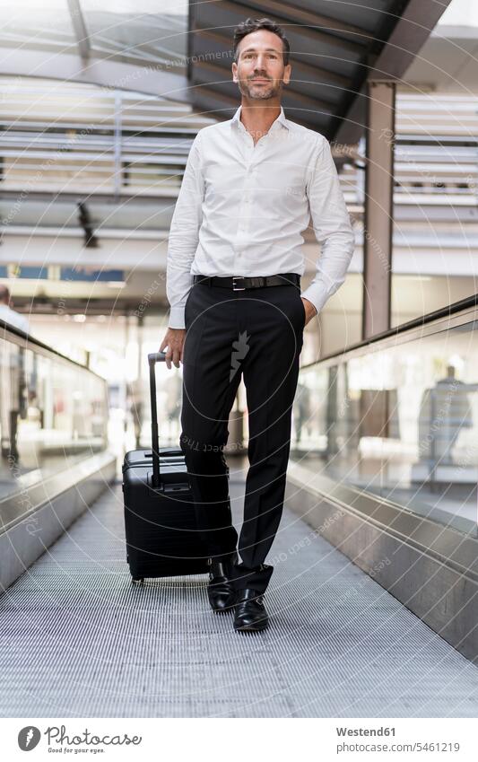 Geschäftsmann auf dem Fahrsteig am Flughafen Leute Menschen People Person Personen Europäisch Kaukasier kaukasisch 1 Ein ein Mensch eine nur eine Person single