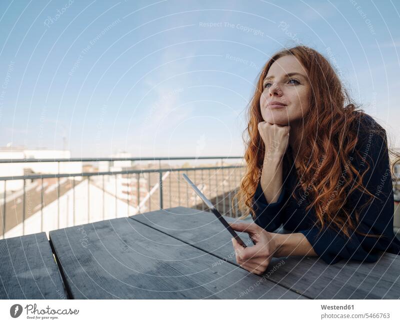 Rothaarige Frau mit Tablette auf der Dachterrasse geschäftlich Geschäftsleben Geschäftswelt Geschäftsperson Geschäftspersonen Businessfrau Businessfrauen