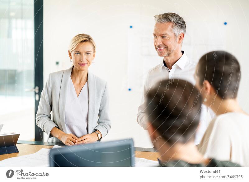 Leitender Geschäftsmann und Frau leiten Workshop im Amt Leute Menschen People Person Personen Europäisch Kaukasier kaukasisch Gruppe von Menschen Menschengruppe