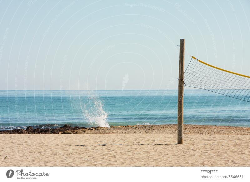 Beach-Volleyball-Feld (Pfosten und Netz) am Sandstrand mit Meer im Hintergrund Beachvolleyball Strand Ozean Spielfeld spielen Ballsportart Urlaub aktiv