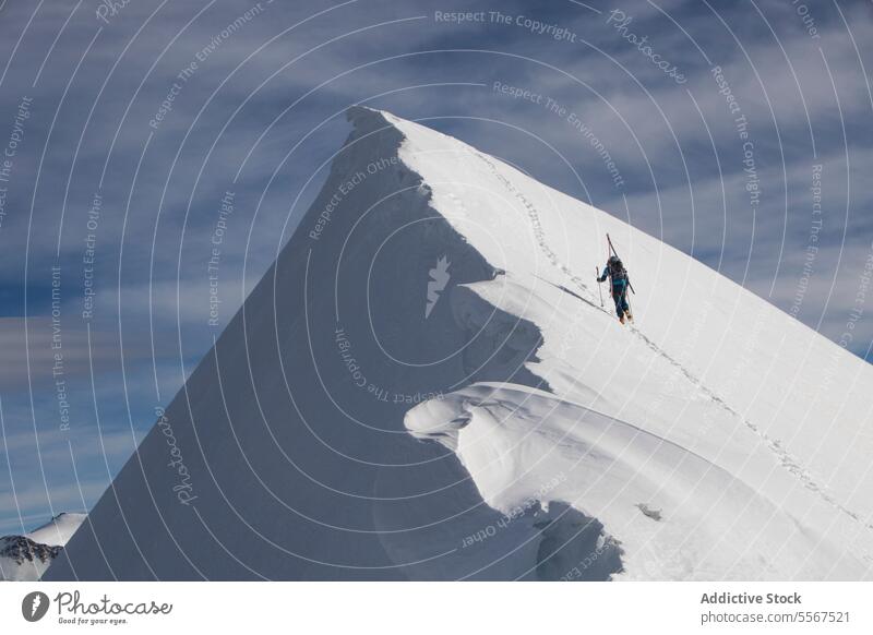 Unbekannte Person, die einen schneebedeckten Berggipfel besteigt Skifahrer Schnee Klettern Berge u. Gebirge unkenntlich Herausforderung anstrengen Mast deckend
