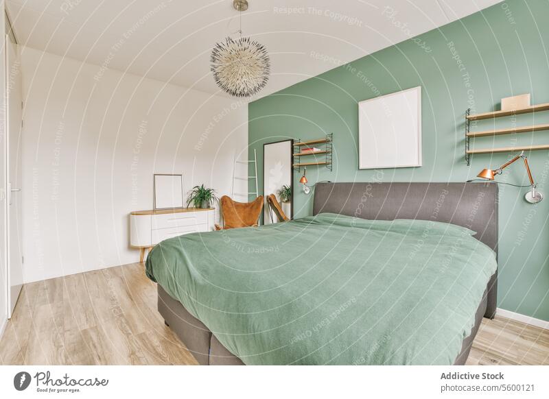 Schlafzimmer mit grüner Wand und Bett groß bequem geräumig Haus heimwärts Stuhl Spiegel Kommode Regal Schmuckanhänger Lampe erhängen Rahmen weiß Laufmasche