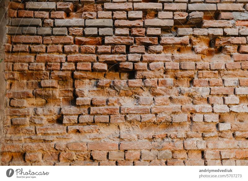 Alte rote Backsteinmauer. Mauerwerk aus einem alten Ziegelstein in einem rustikalen Stil. Struktur und Muster der zerstörten Steinmauer. Industrielle Außen Backsteinmauer Textur Hintergrund