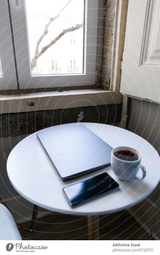 Gemütliches Home Office mit Kaffee und Technik Heimarbeitsplatz Laptop Smartphone Tisch Fenster Baum Ruhe Arbeit Technik & Technologie weißer Tisch gemütlich