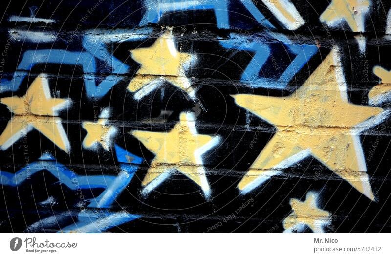 Stern I zeichen Sterne Graffiti gelb blau Mauer Wand Kunst Kreativität Wandmalereien Sternenhimmel Stern (Symbol) Fassade Jugendkultur Schmiererei trashig *