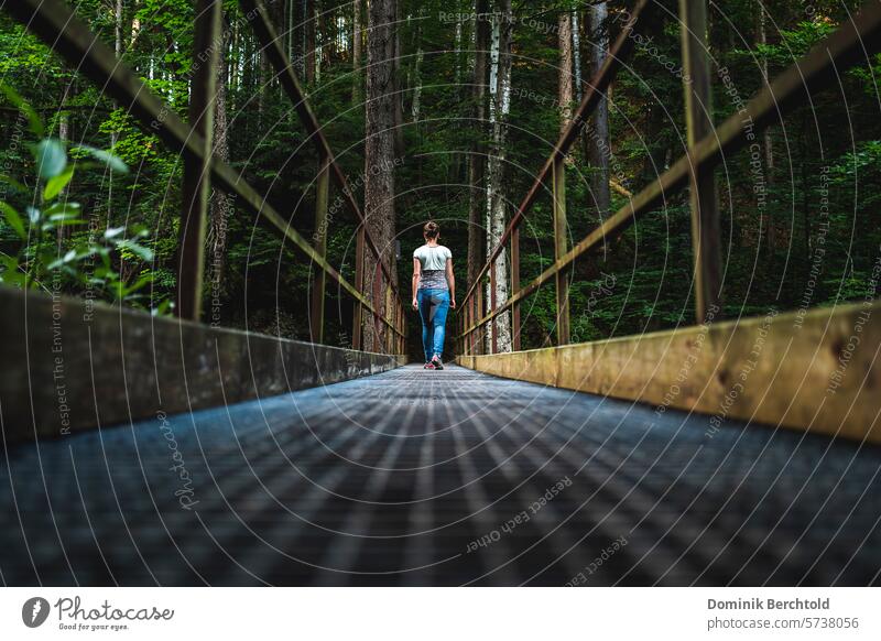 Frau geht über eine Brücke im Wald Sommer Schatten Wolken regen Sonne Berge Fluss Gewässer Bäume Brückengeländer frau Wandern Wanderung Grün Perspektive