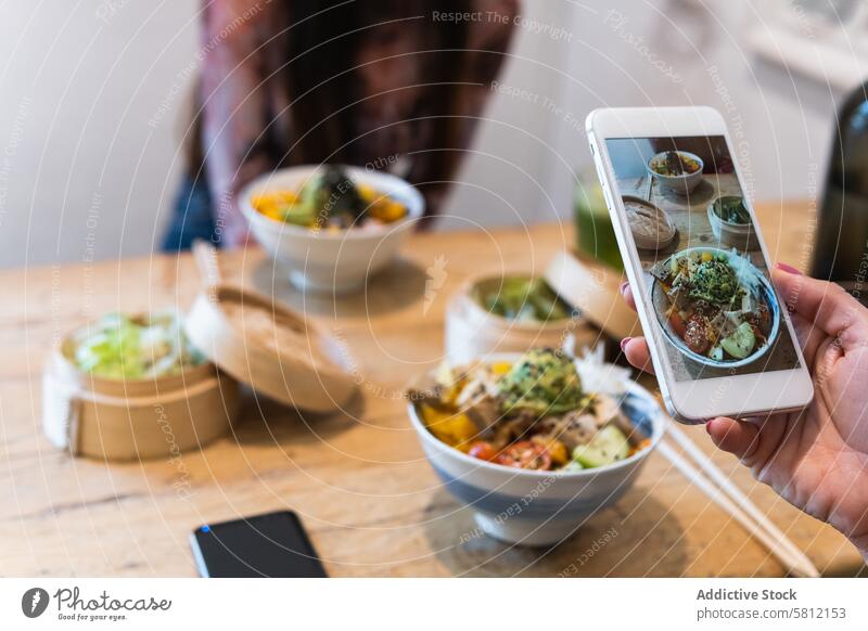 Anonyme Frau fotografiert ein Gericht im Restaurant Frauen fotografieren Speise Food-Fotografie soziale Netzwerke Smartphone Freund Zusammensein Apparatur Gerät