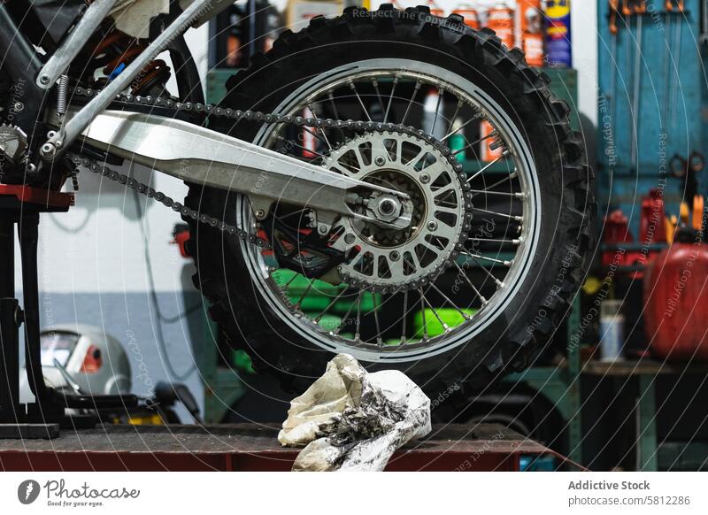 Retro-Motorrad auf Hebebühne in der Werkstatt Rad Flugzeugwartung Garage Fahrzeug Podest heben altehrwürdig Dienst Mechaniker Fahrrad Reparatur retro dreckig