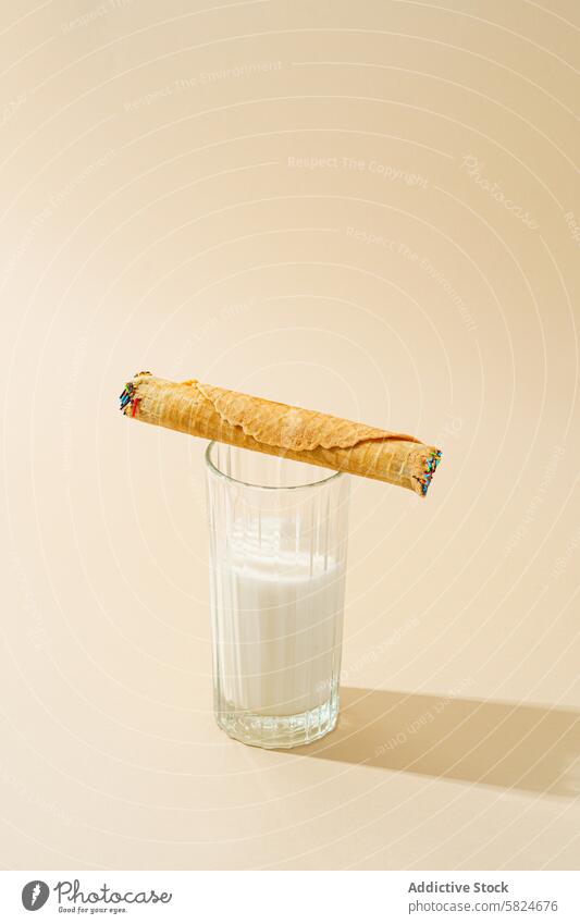 Waffelbrötchen mit Kondensmilch auf einem Glas Milch rollen melken beige Hintergrund Lebensmittel Dessert süß Knusprig gefüllt Lehnen satt Molkerei Snack cremig