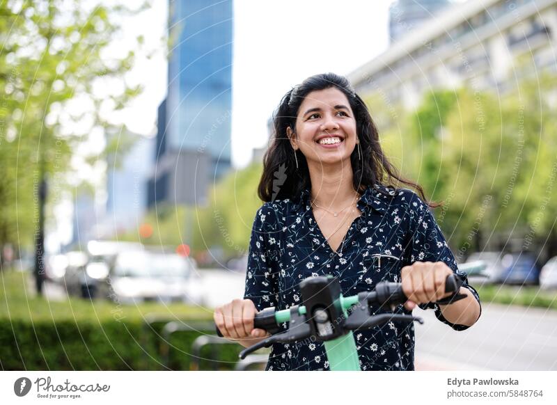 Porträt einer glücklichen Frau mit Elektroroller in der Stadt Inder echte Menschen Großstadt Spaß Sommer genießend Straße reisen im Freien urban Erwachsener