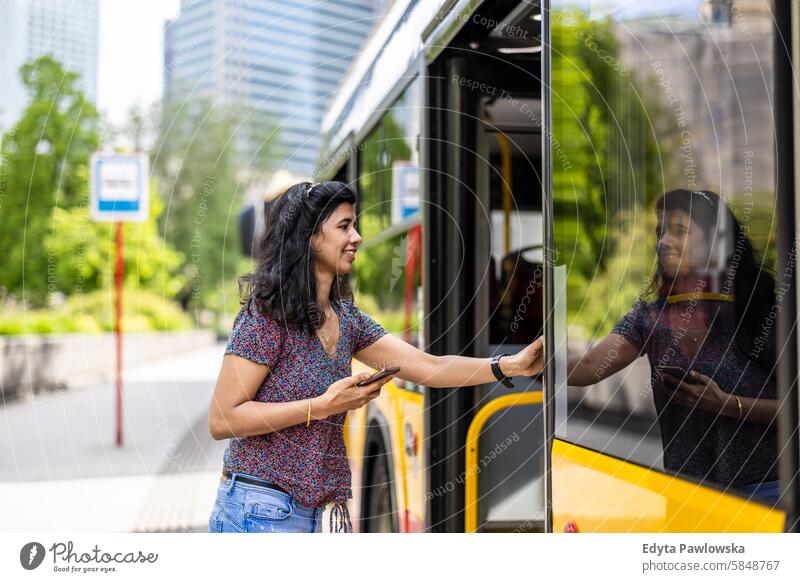 Junge Frau steigt in einen Stadtbus ein Inder echte Menschen Großstadt Spaß Sommer genießend Straße reisen im Freien urban Erwachsener junger Erwachsener