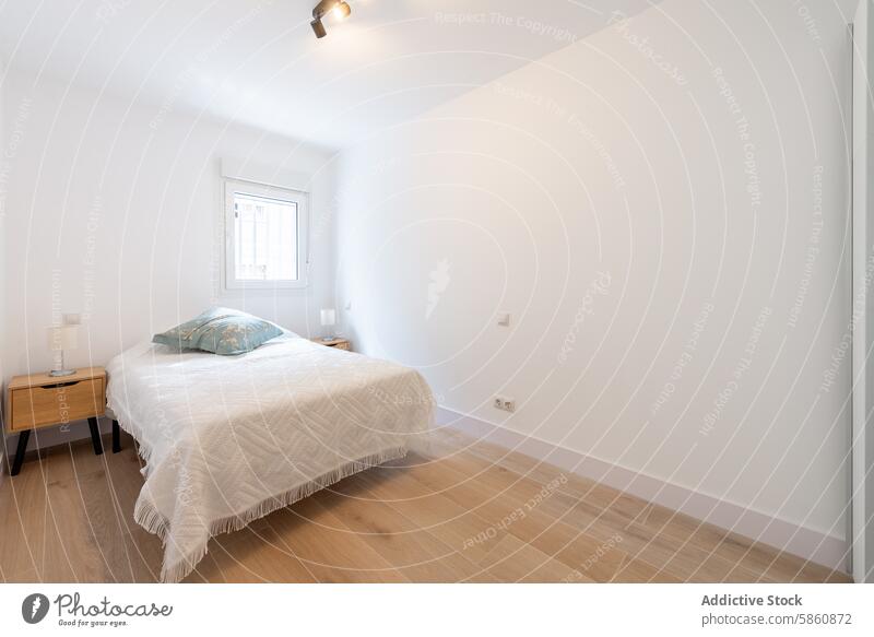 Modernes minimalistisches weißes Schlafzimmer mit stilvollen Akzenten Innenbereich Design modern Dekor gemütlich stylisch hölzern Nachttisch Tisch Bett