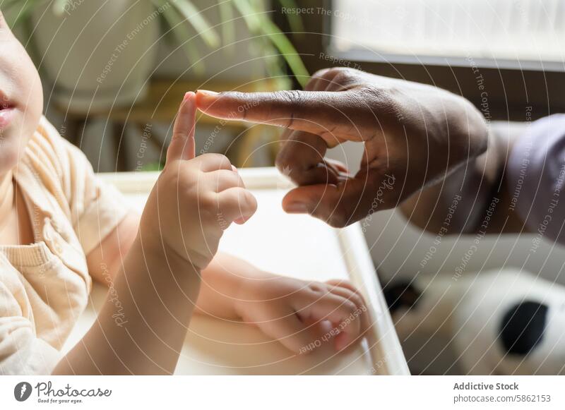 Unterrichtsmoment zwischen einem afroamerikanischen Mann und einem kaukasischen Kind Afroamerikaner Kleinkind Lernen Lehre Fingerzählen im Innenbereich