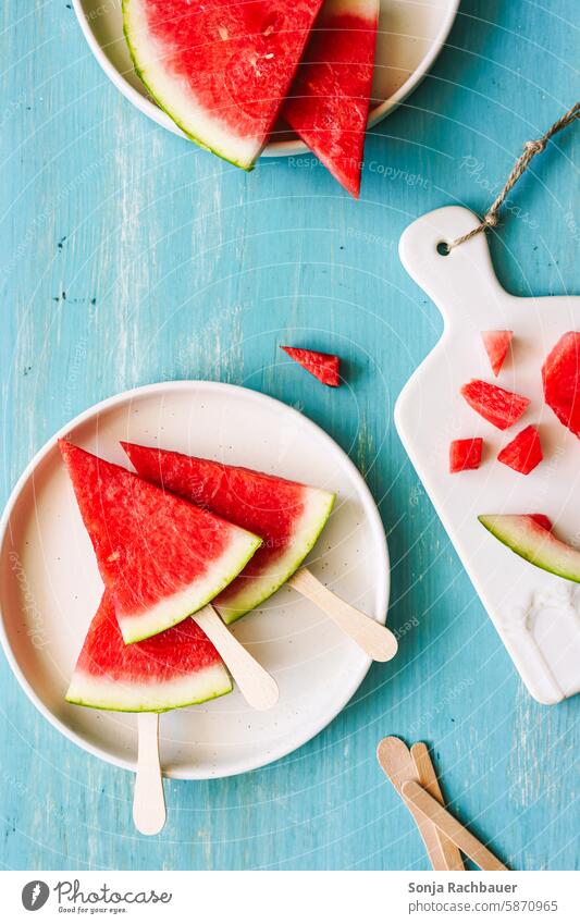 Frische Wassermelonen Stücke auf einem Teller. Draufsicht, türkiser Tisch. Obst Sommer frisch lecker rot Gesundheit süß reif natürlich geschmackvoll saftig