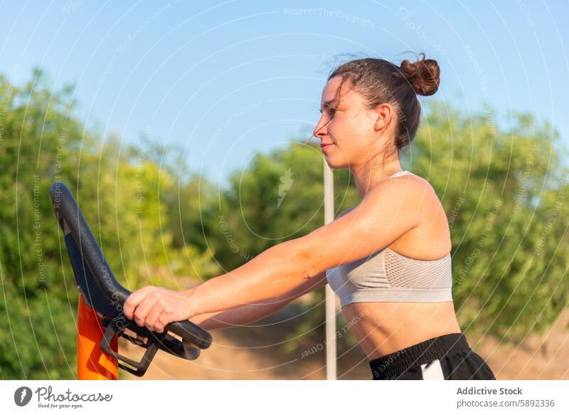 Junge Frau trainiert im Sommer in einem Fitnessstudio im Freien Übung Straße sonnig Fokus anstrengen Training Gerät Gesundheit Sport aktiv Lifestyle physisch