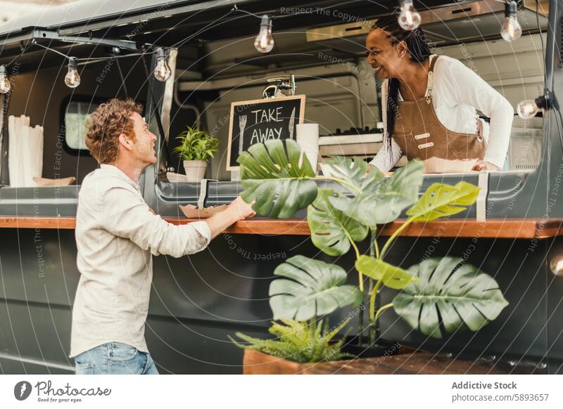 Afrikanische Köchin, die eine Bestellung von einem Kunden in einem Imbisswagen aufnimmt - Fokus auf das Gesicht des Mannes weg Bar Getränk Business Küchenchef