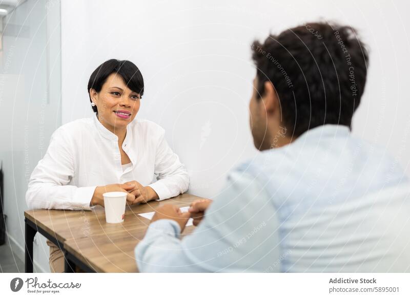 Interaktives Treffen zwischen zwei Kollegen an einem Tisch Frau Mann Sitzung Gespräch Büro professionell kollaborativ schulisch Besprechung weißes Hemd