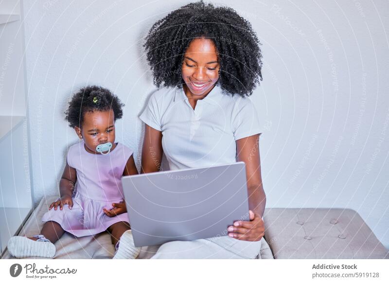 Mutter und Kleinkind beschäftigen sich mit einem Laptop in einem hellen Raum Frau Kind Tochter Computer Bildung Lernen Technik & Technologie Familie heimwärts