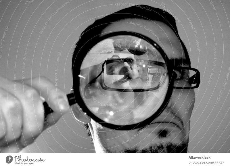 Suchbild untersuchen Suche schwarz Wut böse Brille Selbstportrait Innenaufnahme Blick Lupe käferperspektive Schreibtisch Schwarzweißfoto vergrößert