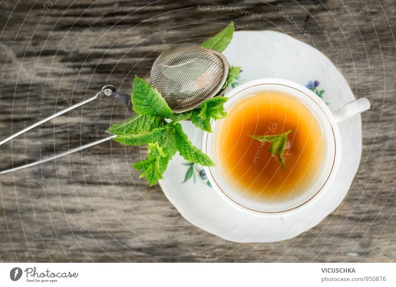 Tasse Tee mit Minze und Teesieb auf alten Holztisch Lebensmittel Kräuter & Gewürze Ernährung Getränk Erfrischungsgetränk Heißgetränk Geschirr Teller Lifestyle